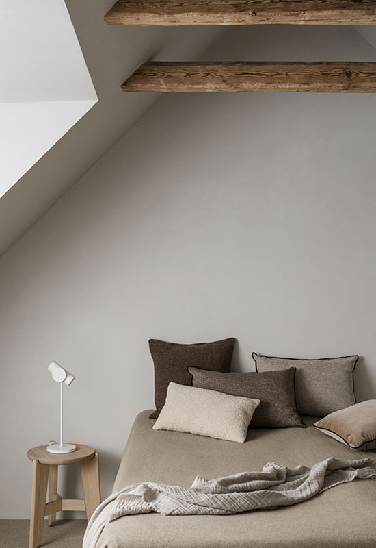 Ambiance minimaliste dans une chambre aux tons gris et bruns taupe