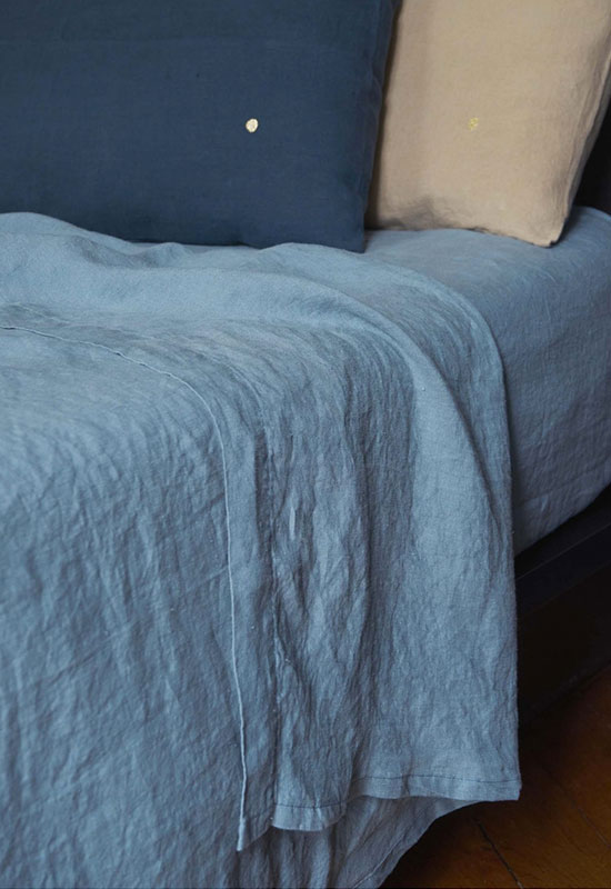 Textiles bleus et beiges pour un lit accueillant