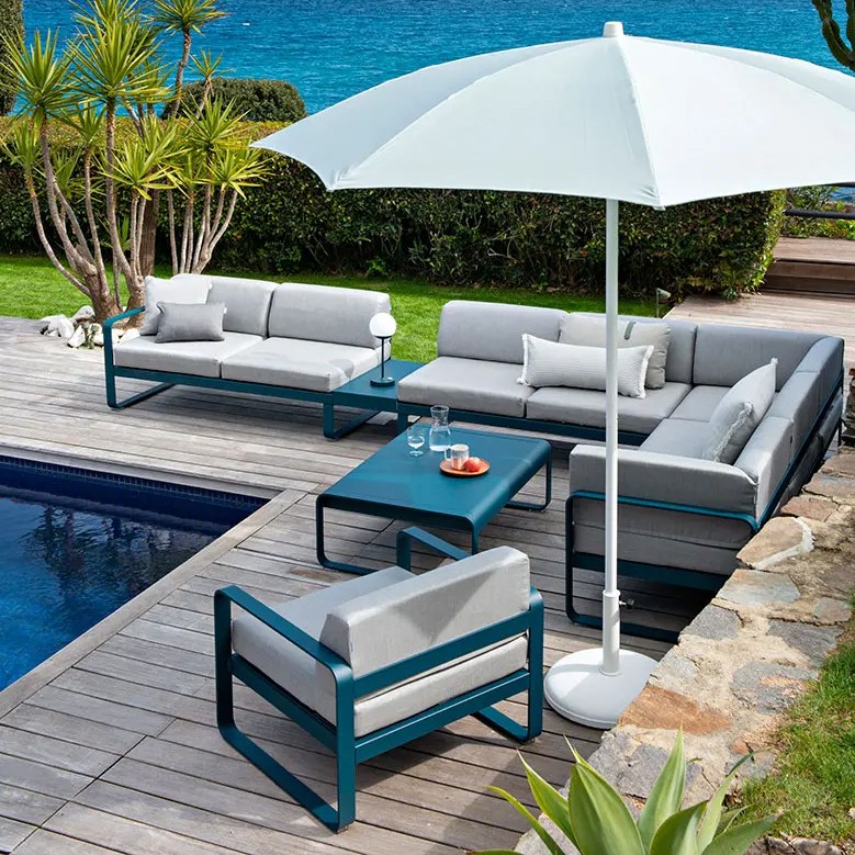 Salon de jardin Bellevie Fermob installé en terrasse au bord de la piscine