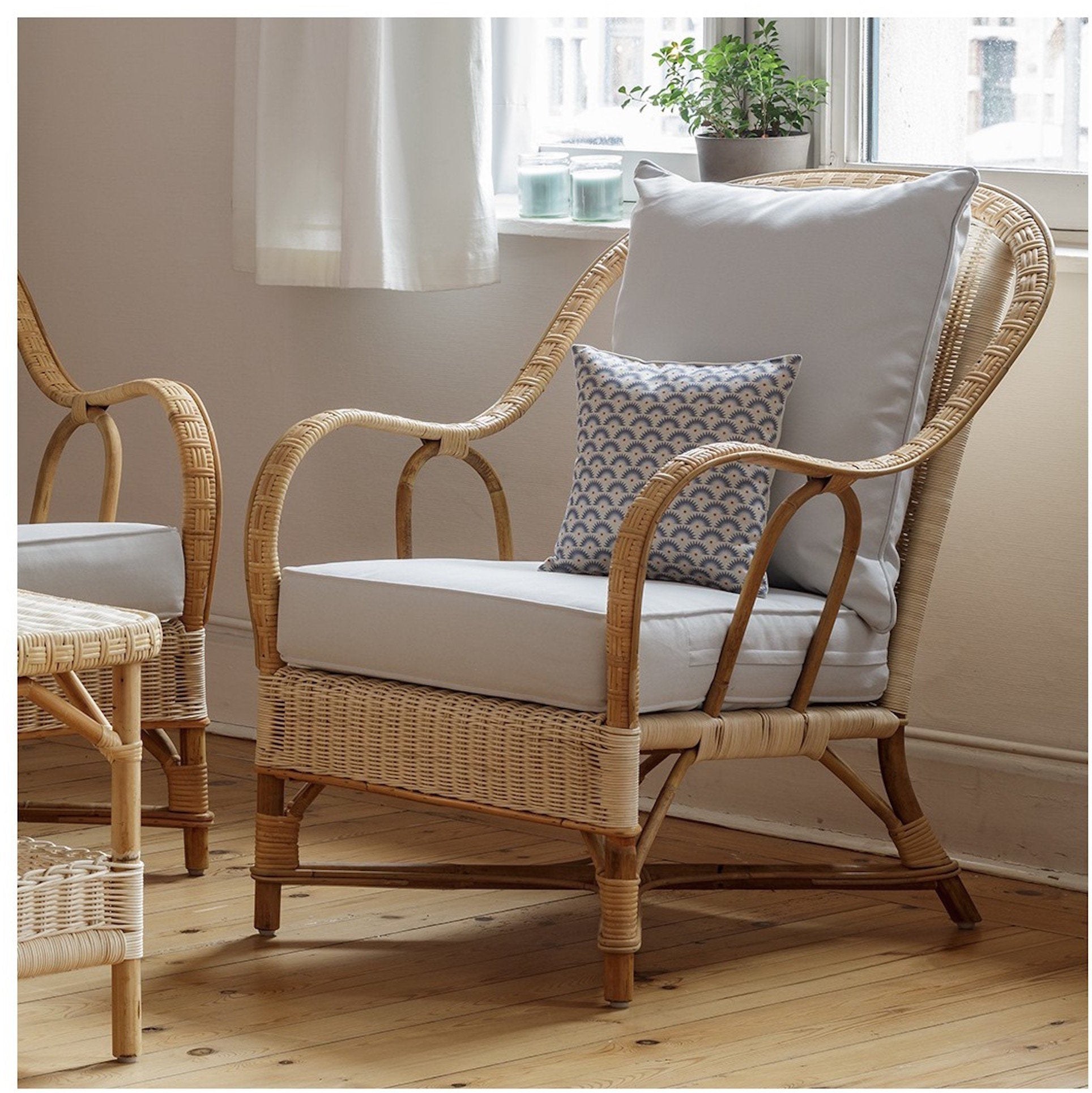Fauteuil en rotin naturel avec coussin Nantucket installé dans un intérieur